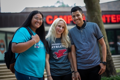 Three Smiling Students in front of the Campus Center
