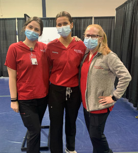 Leah Nagle (center) with classmates Gabby Castellini (left), and Chelsea Price (right) volunteered at the Camden County Vaccination Center to provide COVID-19 vaccinations.