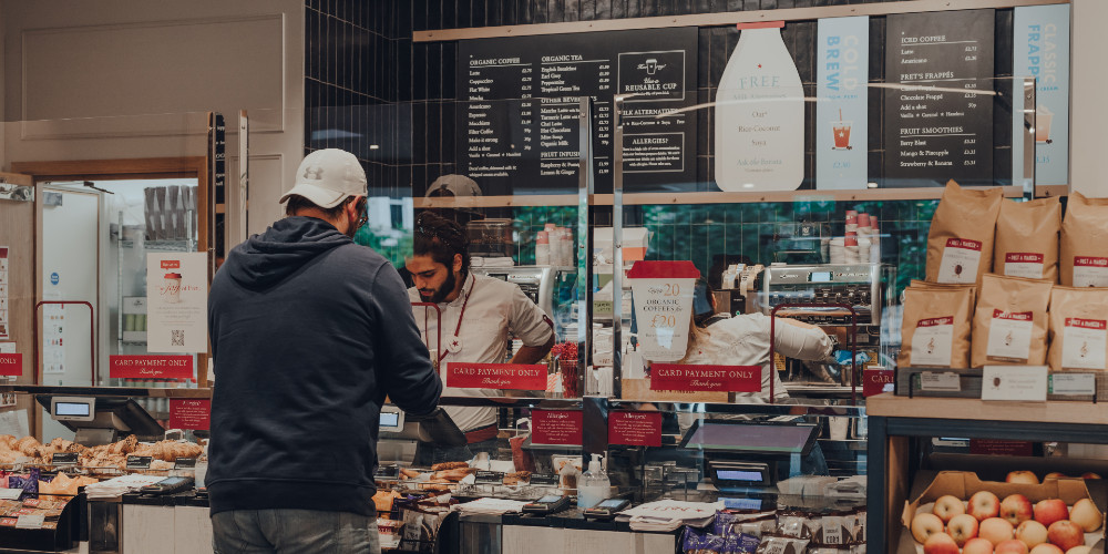 Customer ordering food at a cafe counter