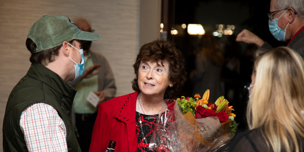 Carol Kaufman-Scarborough speaking with former students Kevin Walsh and Katie Loesch