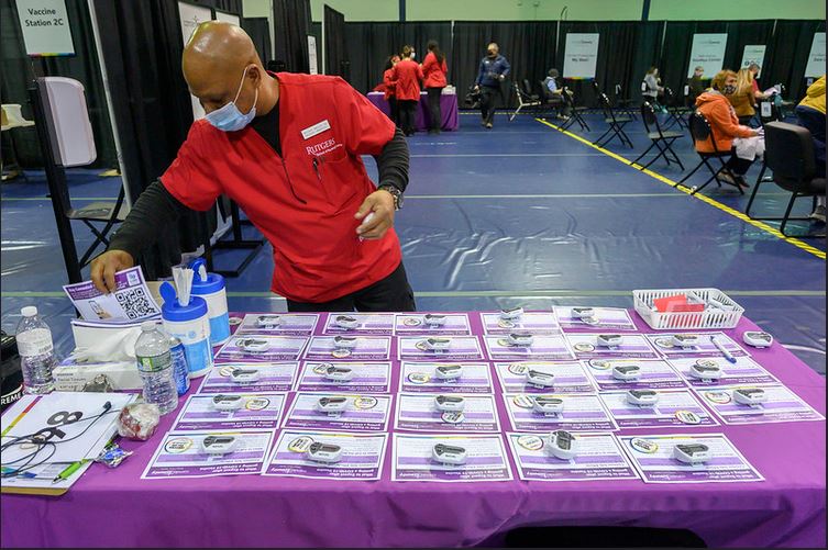 A nursing student manages a vaccination center desk.