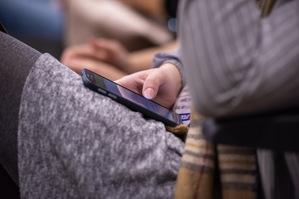 teen on cell phone reading and visibly upset