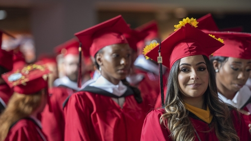 Student in cap and gown at Commencement