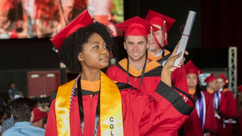 student holding diploma