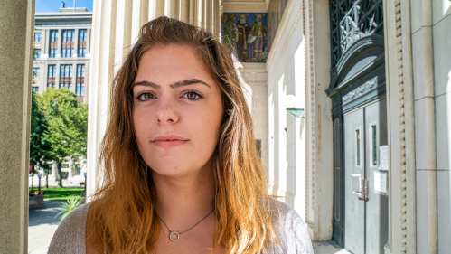 English Communications student stands outside Rutgers building