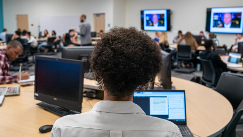 Global studies students in classroom with computers 