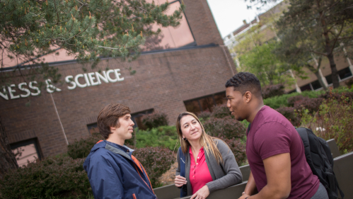 Students talking outside Business & Science building
