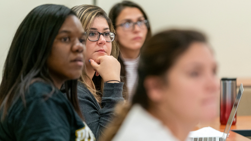 Students listening in a classroom.