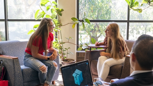 students talking while sitting in lounge