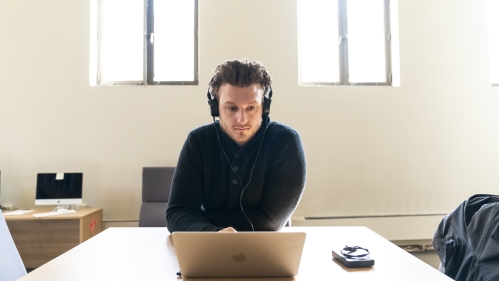 Person with headphones at computer