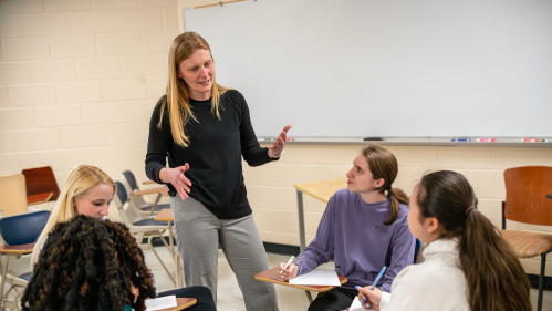 Small group of students having discussion at circle of desks