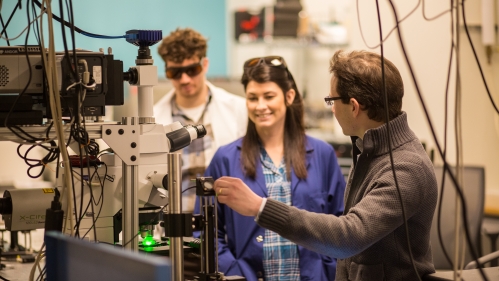 students and professor in lab