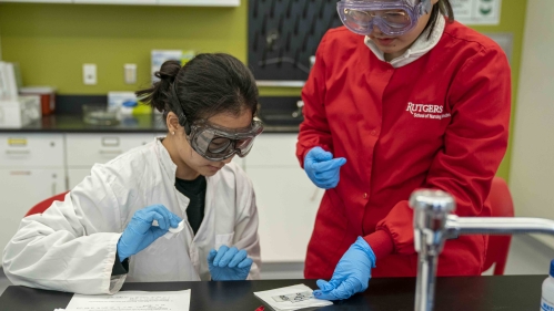 two women in safety gear working in lab