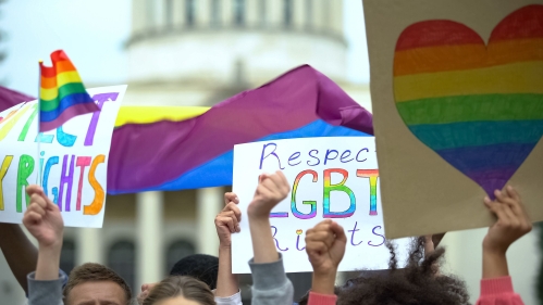 Protesters outside the White House with LGBTQ+ signs