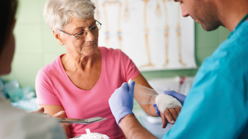 Patient having hand would dressed with gauze.
