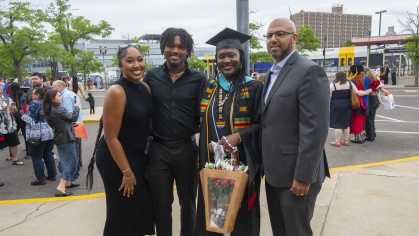 Commencement 2024 graduate taking photo with family