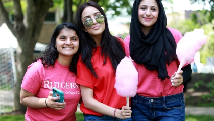 students in red holding cotton candy