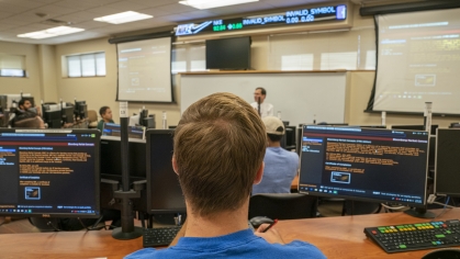 back of man's head in computer lab
