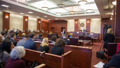 the interior of a court room filled with law students watching the proceedings