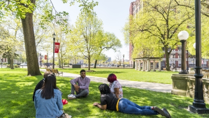 students sitting together on the lawn