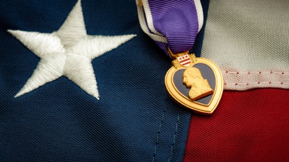 Purple Heart medal on top of American Flag