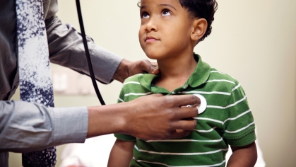 male child being examined by healthcare professional
