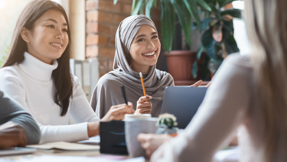 woman in hijab talking at table