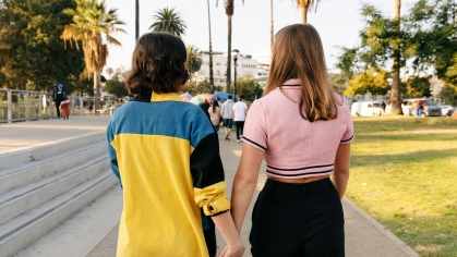 couple holding hands walking