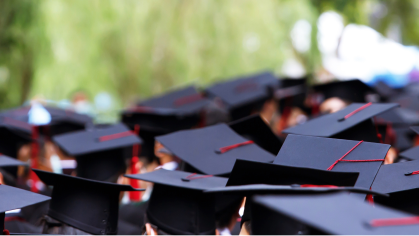 Photo of graduates in caps and gowns.