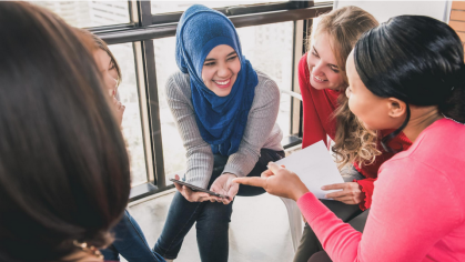 Diversified students sitting and laughing together