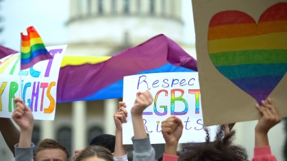 Protesters outside the White House with LGBTQ+ signs