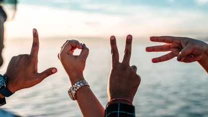 L.O.V.E. spelled out in fingers and hands