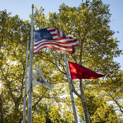 American and Rutgers flags flowing in distance 
