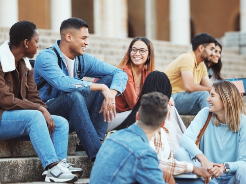 college students sitting on steps and laughing