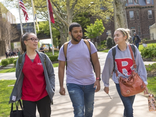 three students walking along rutgers-camden campus