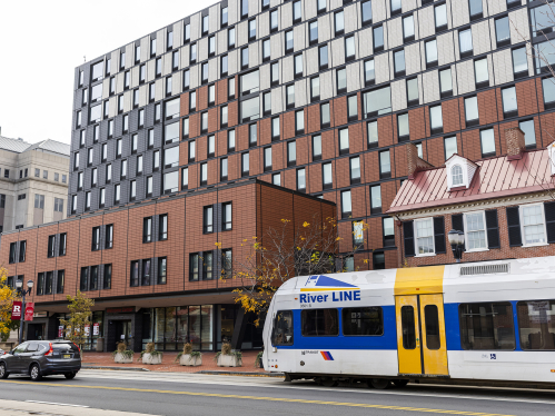 330 Cooper Residence Hall with RiverLine Light Rail passing in front