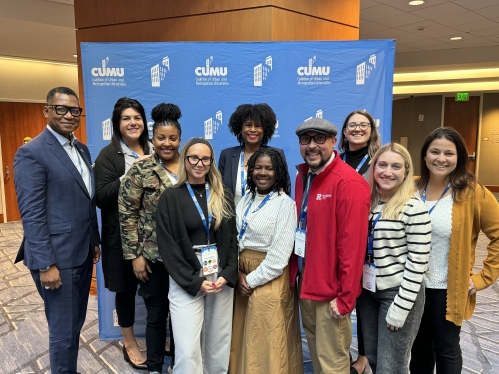 Staff from the Urban Innovation Fund standing in front of a blue banner