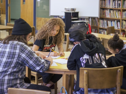 Ignite students at table in library doing work