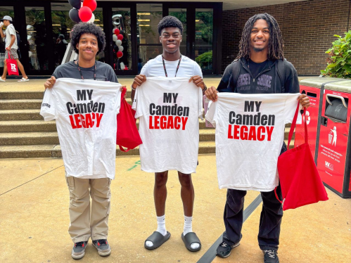 Students holding Orientation T-Shirts in from of the Campus Center