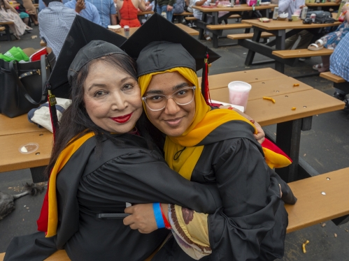 Commencement 2024 mom hugging graduate at picnic