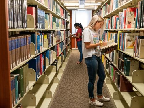 student in library