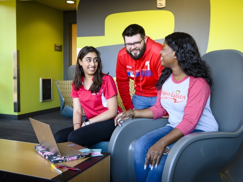 students talking while sitting in lounge