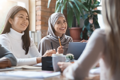 woman in hijab talking at table