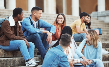 college students sitting on steps and laughing