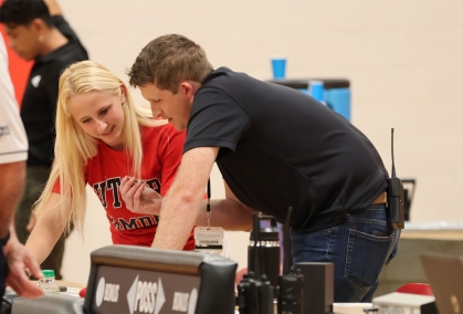 Kaila Crozier works as an announcer during a Scarlet Raptors atheltic event