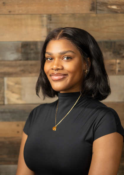 Headshot of a student wearing a black shirt in front of a textural background