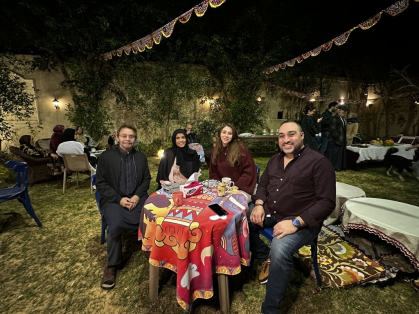 Dr. Habib dines outside with members of host Magda's family