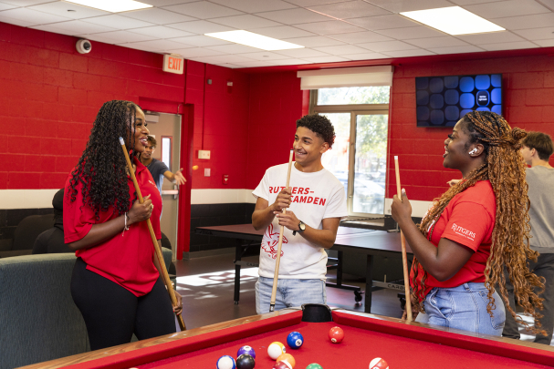 Students in Housing Complex enjoy a game of pool inside the residence hall