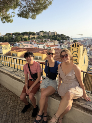 Three students smile against a Barcelona backdrop.
