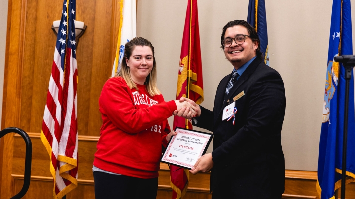 Student Tia Gillies receives a scholarship during the 2024 Chancellor's Veterans Day Luncheon